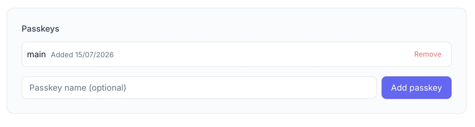Settings > Security section showing one registered passkey in the list (name, registration date, Remove button) and the Add passkey input field + button below it.